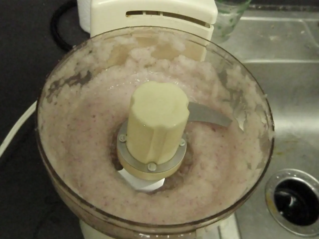 There is a mixer grinder. Inside that there is some item. Also there is a hole on the right corner.