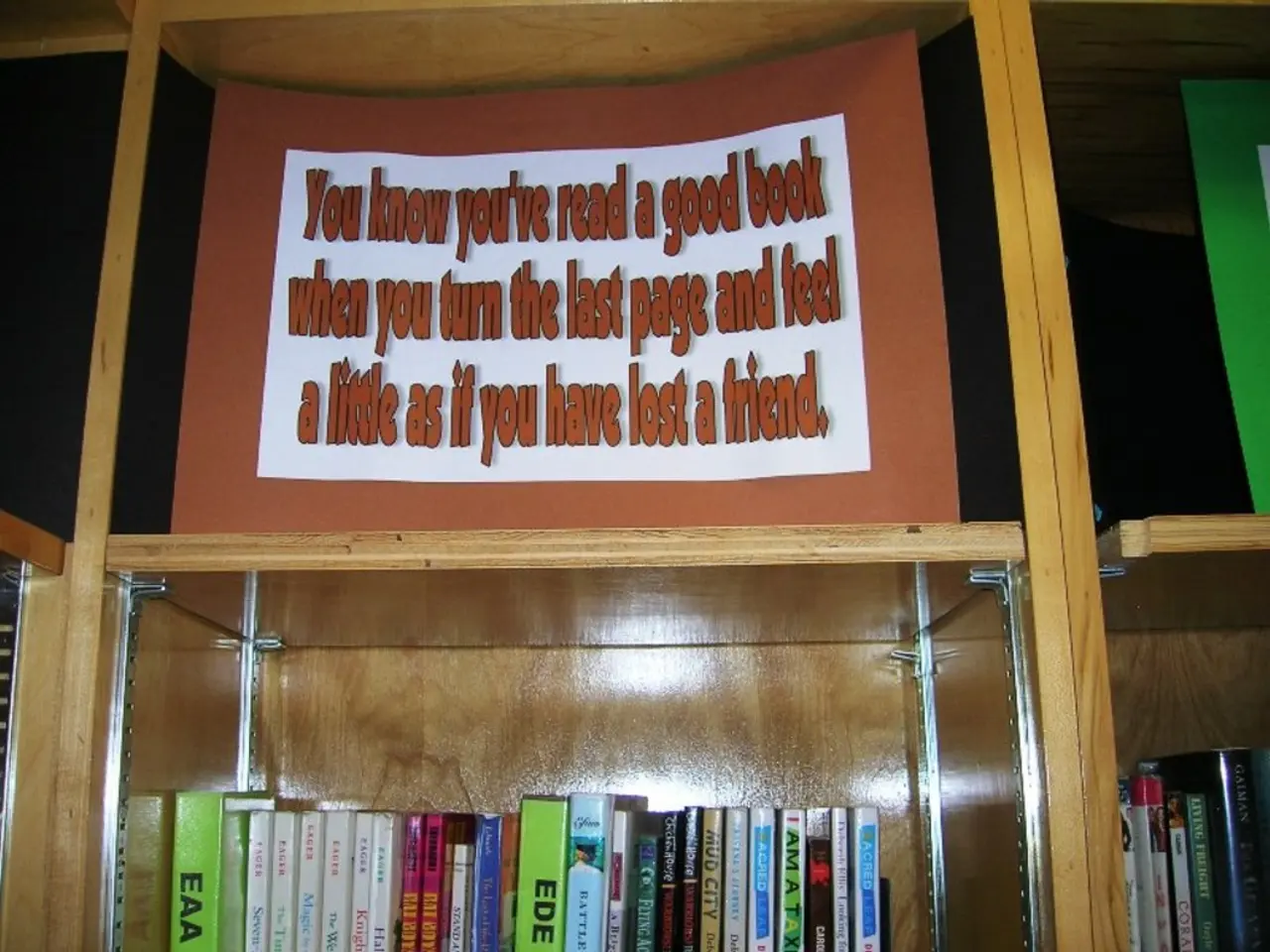 In the image there are some books in the rack and above there is a card with some text on it.