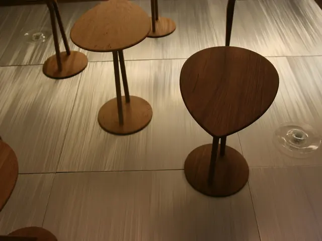 In this image there are empty stools and there are glass objects.