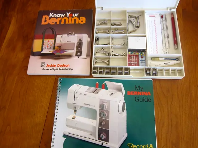 In this image there are two books and a tool box with some tools in it on top of a table.